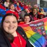 Image of Tracy Brown at a Wales match holding a rainbow flag