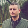 Head shot of a white man with short dark hair.