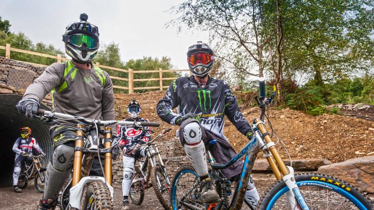 two mountain bikers  wearing helmets on their bikes at Bike Park Wales