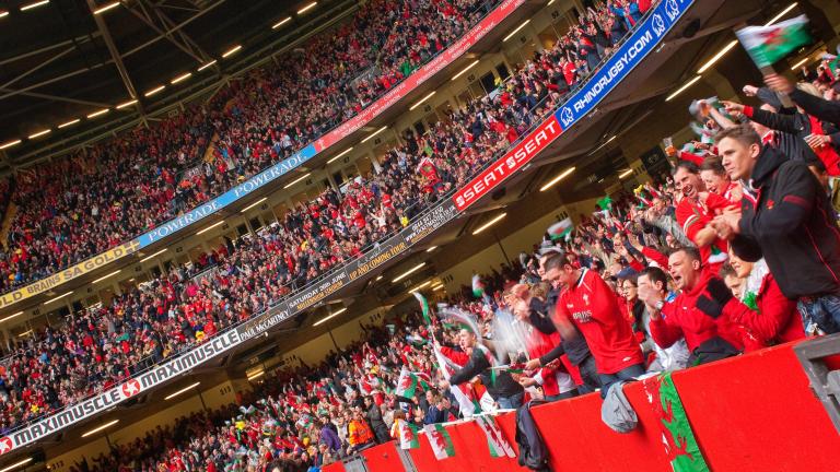 A large crowd of Welsh rugby fans inside a stadium