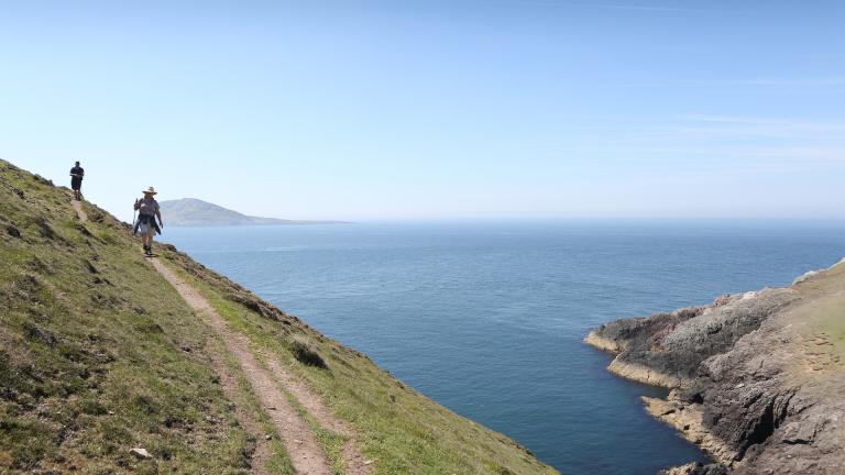 Couple walking on Aberdaron section of the Wales Coast Path