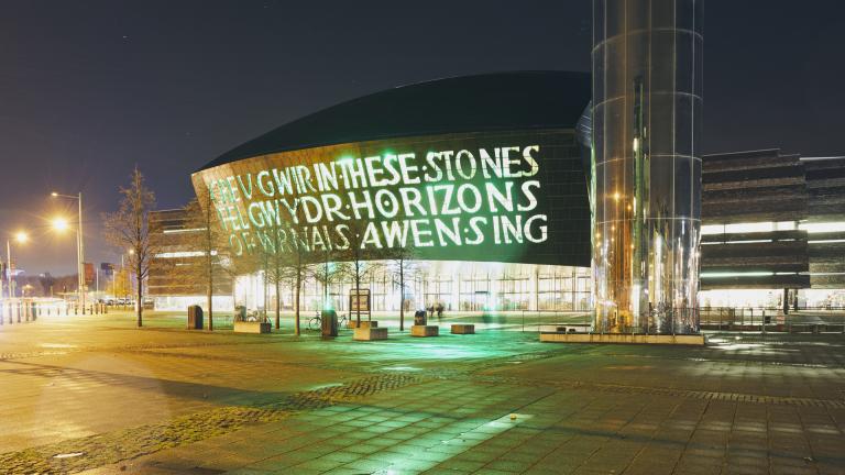 building with writing and mirrored tower (Wales Millennium Centre, Cardiff Bay).