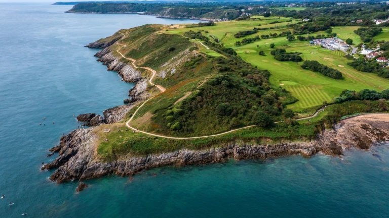 Aerial view of a green peninsula surrounded by a blue sea