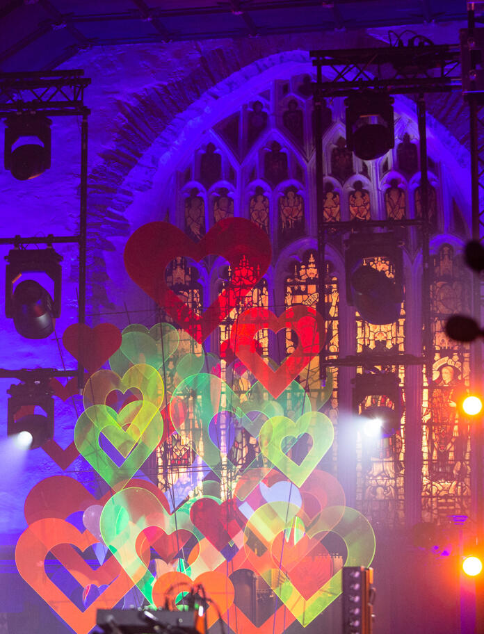 Inside an old church, decorated with multicoloured Perspex hearts and beautiful lighting. 