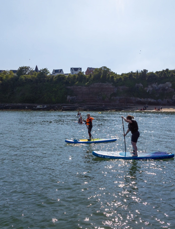 People paddle boarding on the water.