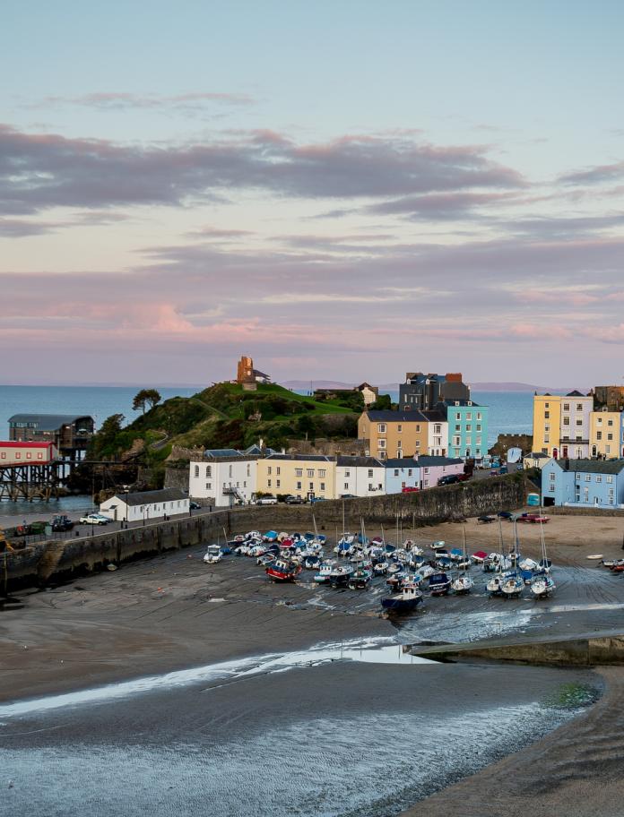 Image of Tenby Harbour beach, colourful houses and the lifeboat station