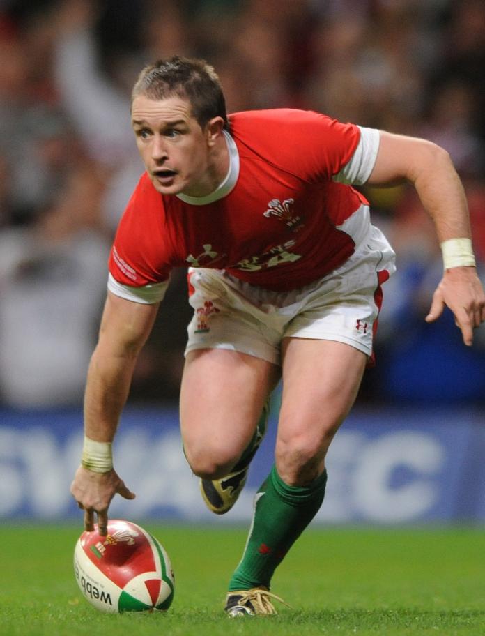 Shane Williams with the ball on a rugby pitch
