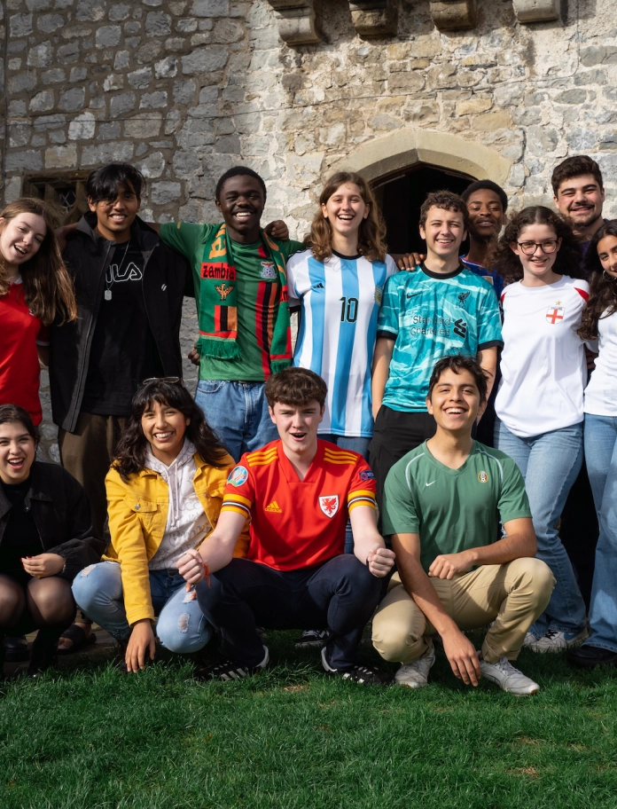 A mixed group of young people wearing a variety of different football kits
