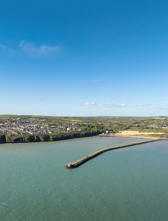 A view of the sea with the land in the distance.
