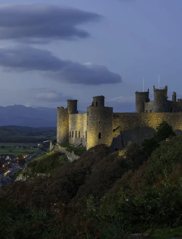 A view of Castell Harlech/Harlech Castle at dusk