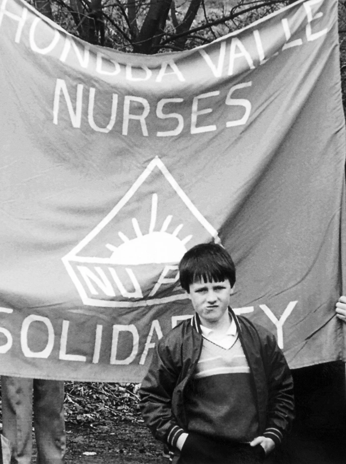 People standing in front of a banner.