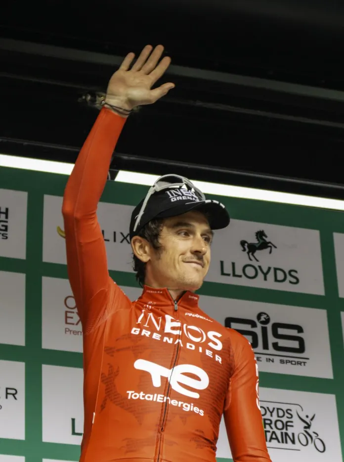Geraint Thomas waving on stage an awards ceremony.
