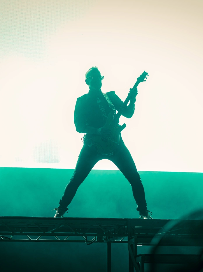 The silhouette of a guitarist on stage
