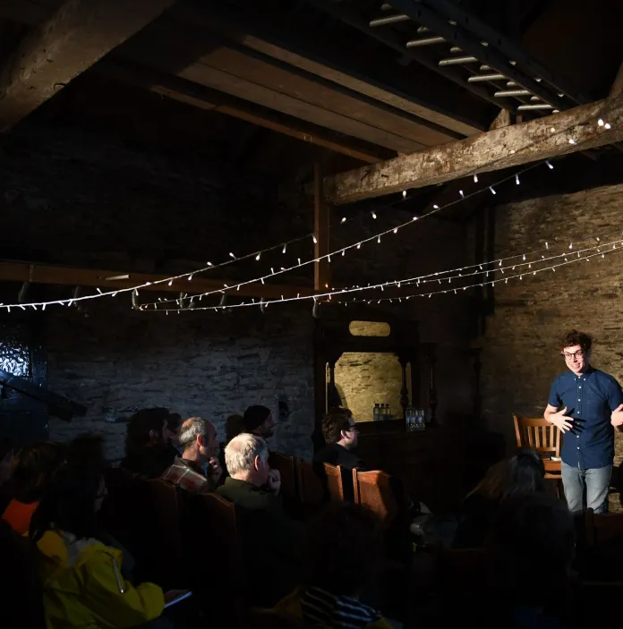 A comedian on stage in front of an audience.