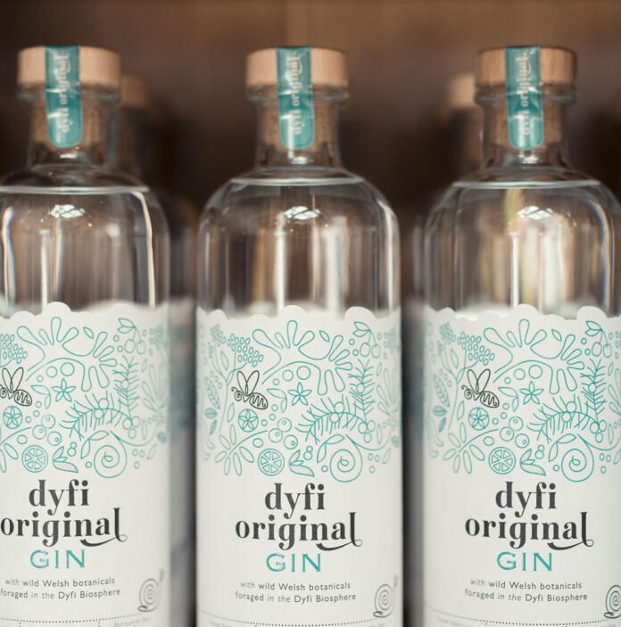 Dyfi original gin bottles lined up on shelf