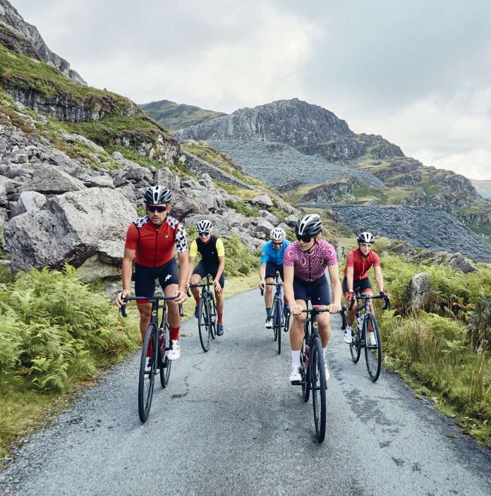 A group of people cycling through beautiful mountains