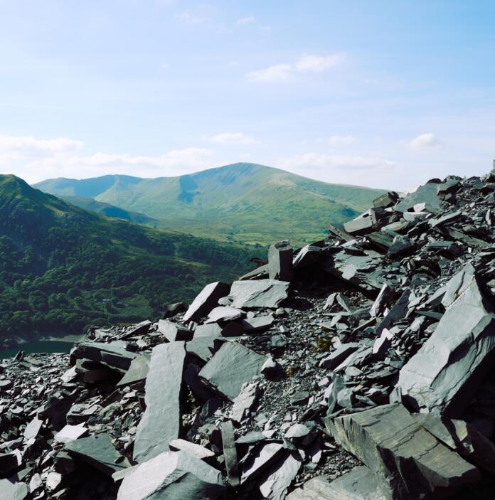 A scenic shot across a numbers of mountains covered in slate