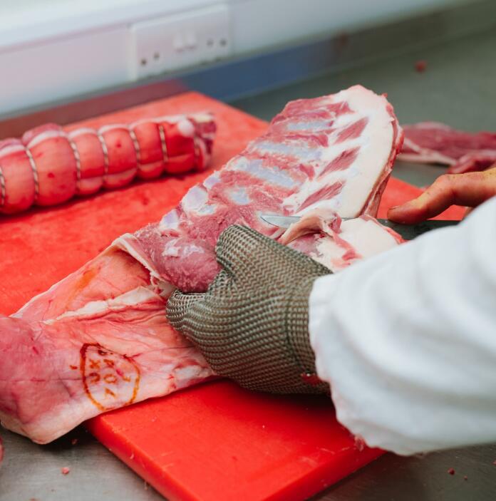 A butcher cutting up some Lamb.