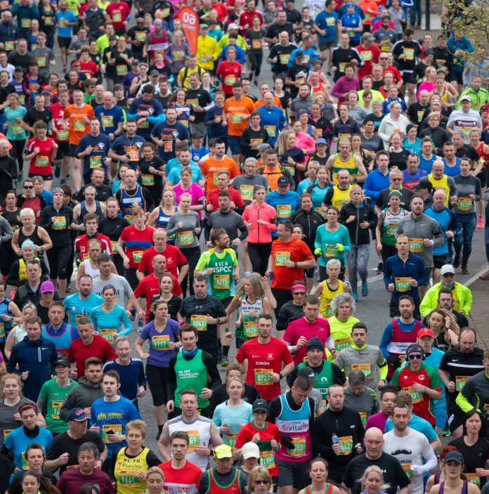 A large group of people running a marathon in Newport, South Wales.