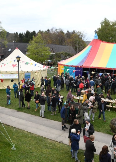 People standing in groups at the festival.
