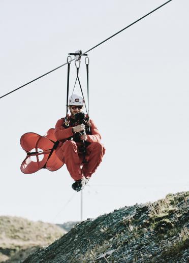 Matthew Rhys sliding down a zip wire image
