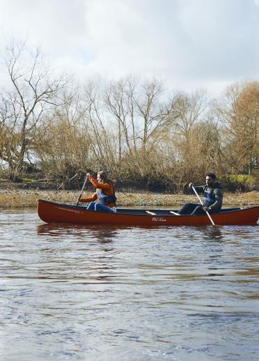 Zwei Personen fahren in einem Kanu auf dem Fluss Wye in Südwales.