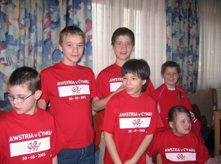 A group of children wearing red football tops.