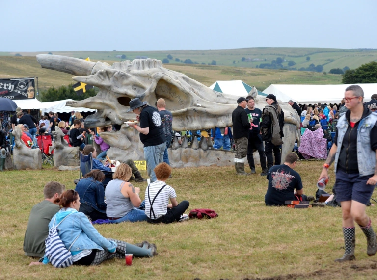 People sat in a field at the festival.