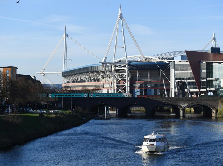 A view of the exterior of the stadium next to the river.