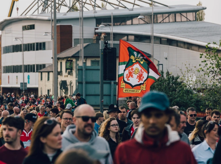 A crowd of people holding flags.
