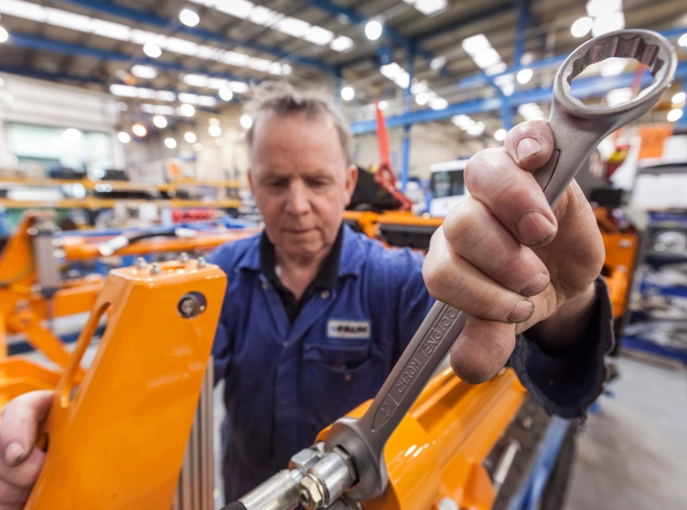 Male employee servicing equipment