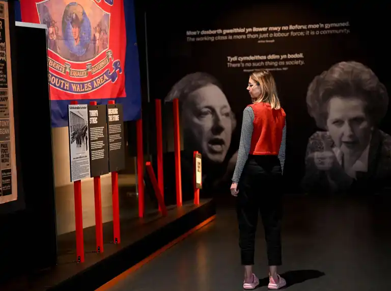 A person looking at the exhibition in the museum.