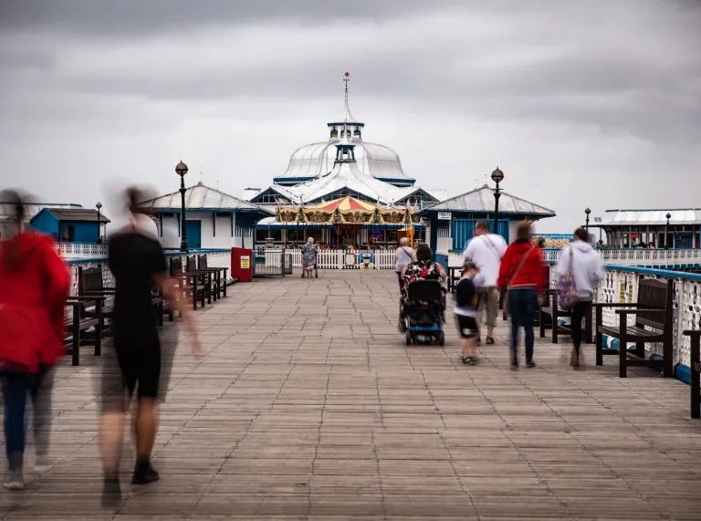 People walking along the pier.