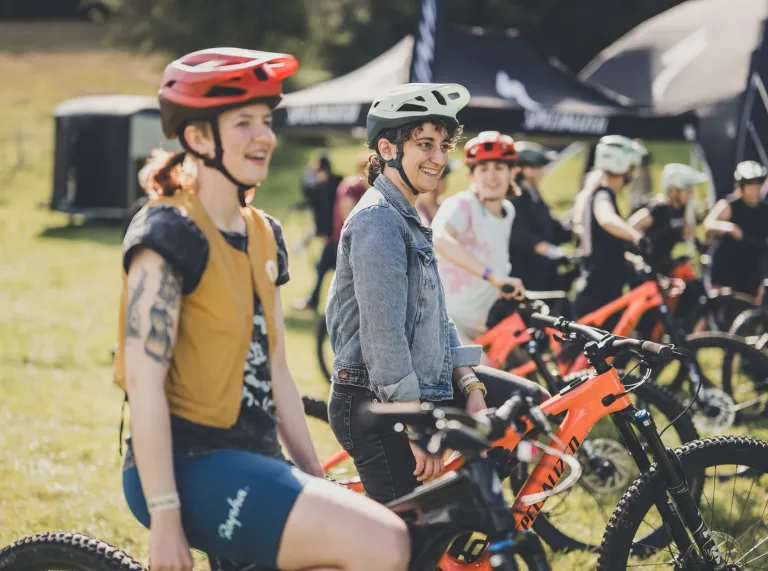 A group of women sitting on their BMX bikes