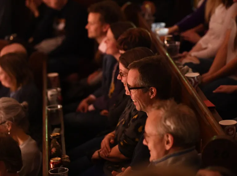 A close up image of the audience laughing.