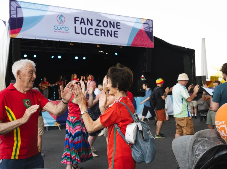 Wales fans enjoying live music and dancing at the UEFA Women's EURO 2025 fan zone in Lucerne.
