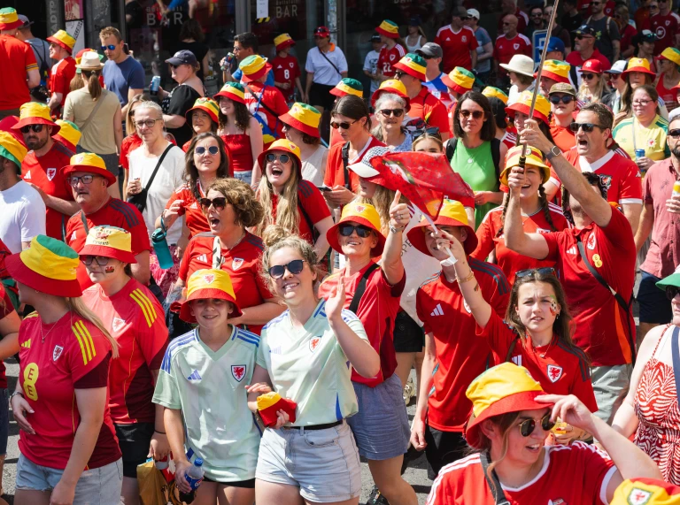 Wales supporters gather in a fan zone ahead of a UEFA Women's EURO 2025 match in Switzerland. 