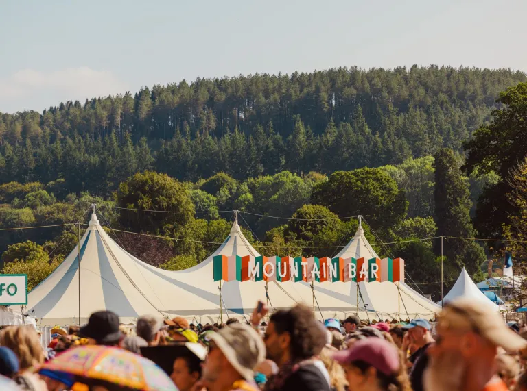 A large tent at the festival with trees in the background.