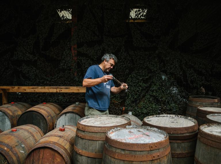  Andy Hallett tests cider from one of many barrels at Blaengawney Farm.