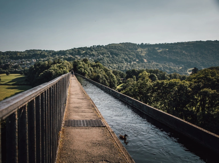 A narrow aqueduct set high above green scenery