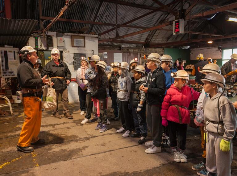 A tour group ready to head into the mine with a tour guide.