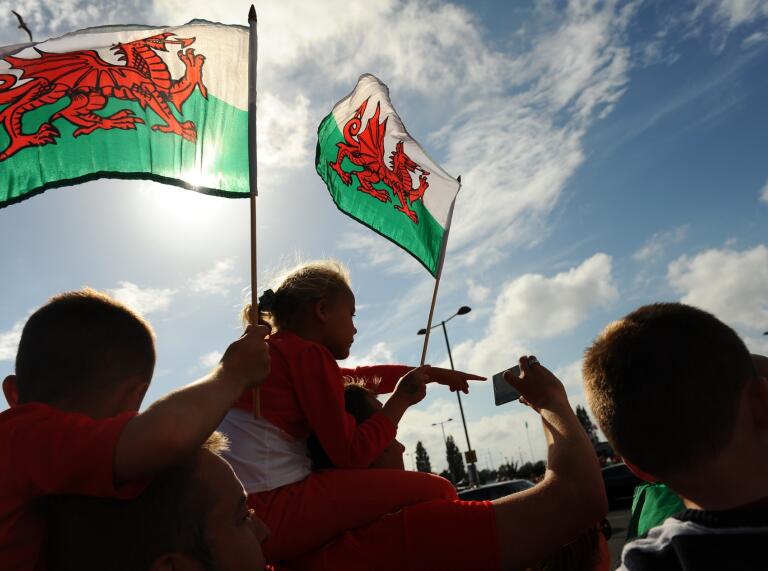 A child flying the Welsh flag.