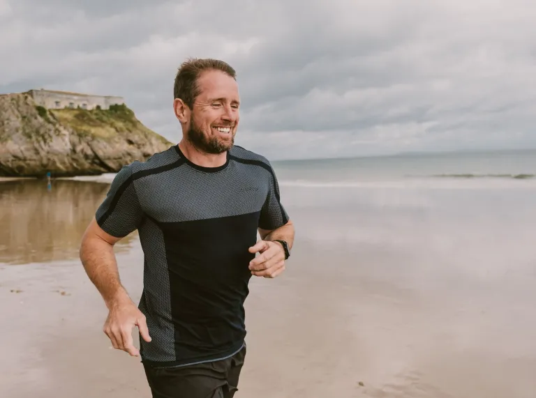 Shane Williams running along the beach.