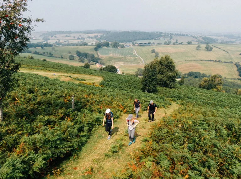 A group of people walking through the countryside.
