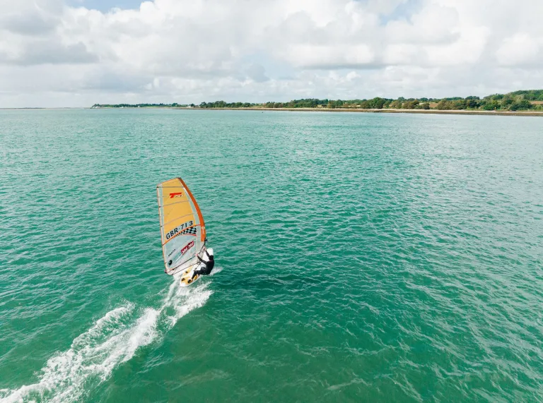 A person windsurfing across the sea.