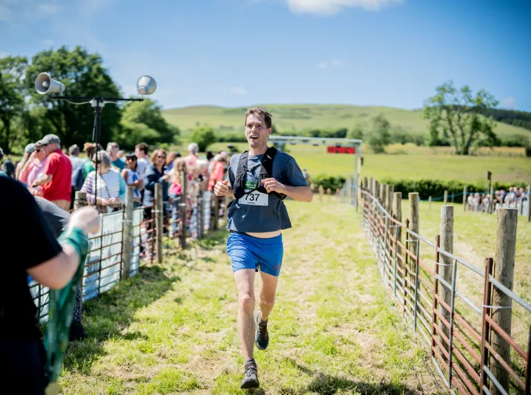 A runner reaching the end of the Man vs Horse race in Wales