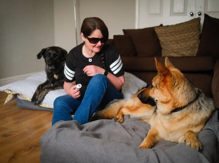 Julie Thomas at home with her two guide dogs.
