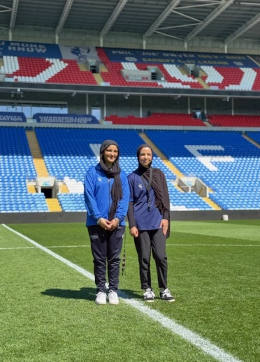 Eleeza and Rosheen standing in Cardiff City Stadium