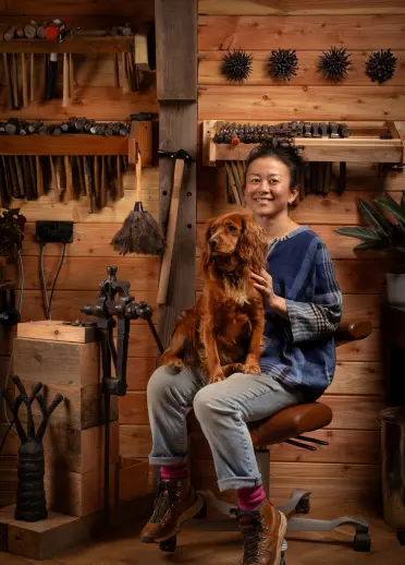 Artist Junko Mori with her dog in her workshop