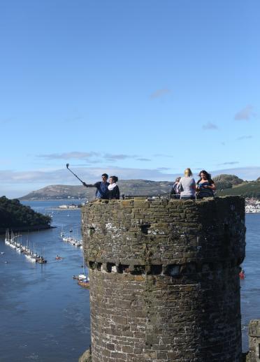 People taking selfies on tower Conwy Castle